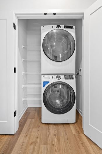 a white washer and dryer in a small room